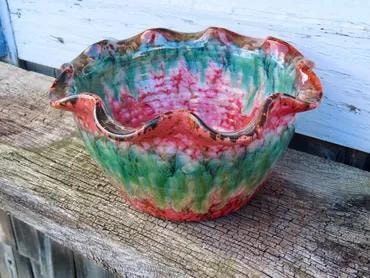 Ruffled ceramic bowl with vibrant glaze