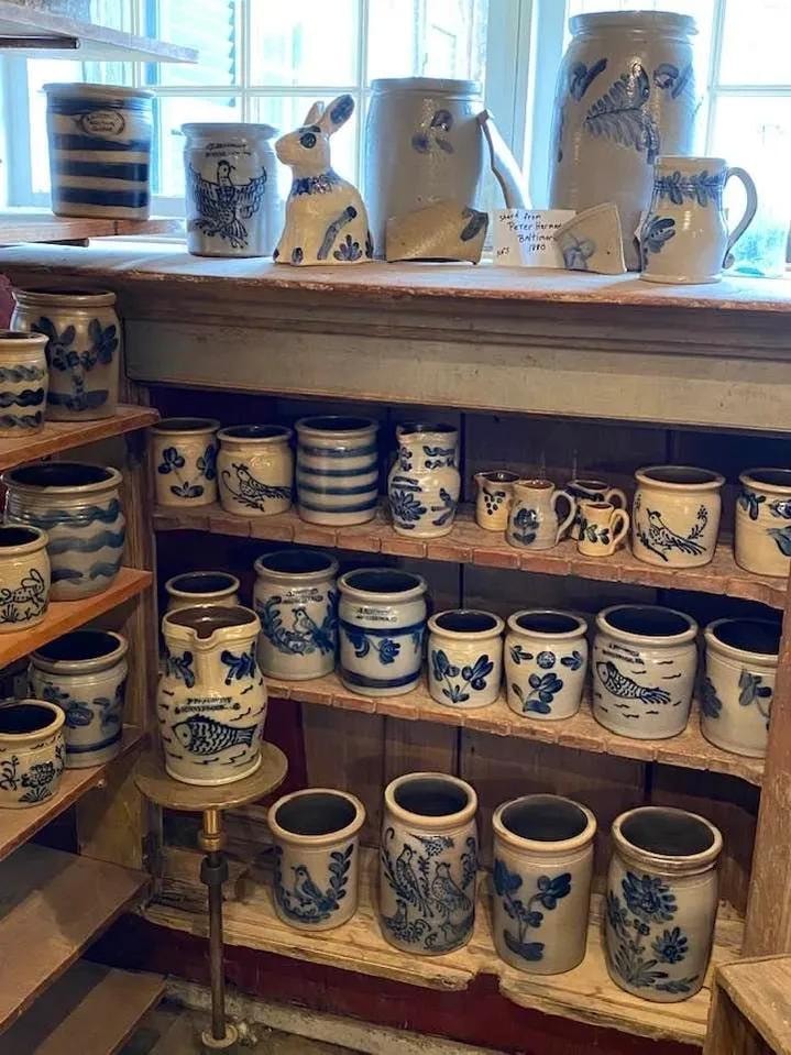 Blue and white stoneware crocks on wooden shelves