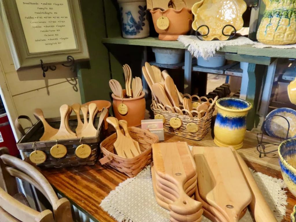 Wooden utensils, bread boards, and handmade pottery in the shop